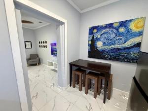 a room with a painting on the wall and a table at View Private Suite near LEGOLAND, Downtown & Hospital in Winter Haven