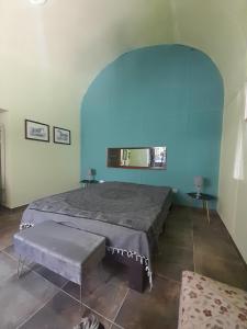 ein Schlafzimmer mit einem Bett und einer blauen Wand in der Unterkunft Lumie in Palermo