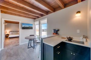 a kitchen with blue cabinets and a table in a room at LUXX Taos Motor Lodge in Taos