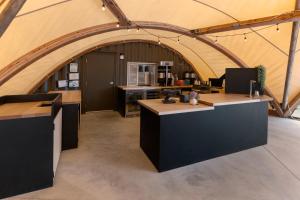 a large kitchen with an archway in a tent at Under Canvas White Mountains in Dalton +34 photos