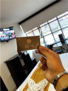 a person holding up a bar of chocolate in a restaurant at House Studio Hotel in Bogotá