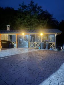 a building with a lot of windows at night at Vatra Bunătăților- By The Lake in Proeni +16 photos