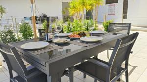 a table with glasses and plates of food on it at Oasis by Templesuites - Praia da Rocha in Portimão