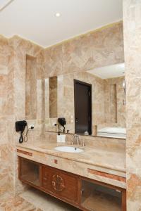 a bathroom with a sink and a large mirror at Munir`s residence 2 in Cairo +291 photos