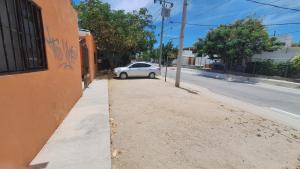 a white car parked on the side of a street at Las Veredas Aeropuerto in San José del Cabo