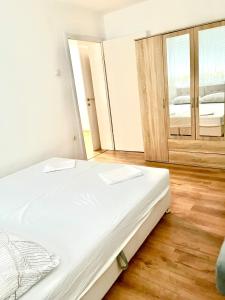 a bedroom with a bed and a large mirror at Tinela in Mostar +1 photo