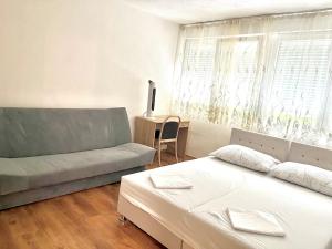 a living room with a bed and a couch at Tinela in Mostar