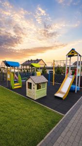 a playground with several slides and a slide at Sunsar in Sarbinowo