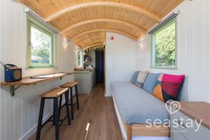 a tiny house with a bed and a kitchen at Sea Farm Stays in Broadstairs