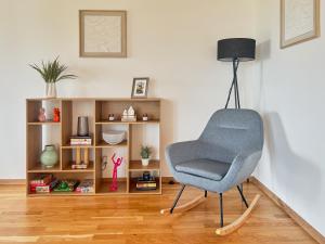 a chair in a living room with a book shelf at Chaletka Tatry in Nová Lesná +48 photos