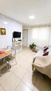 a living room with a couch and a table at Apt da Leily in São Luís