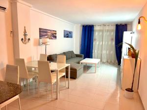 a living room with a table and a couch at APARTBEACH NARGAM Vista Playa in La Pineda