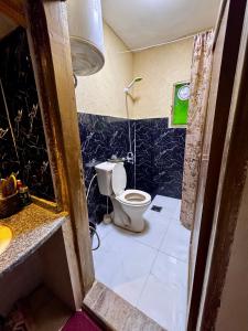 a bathroom with a toilet and a sink at Oak Farm مزرعة الملّول in Ajloun +20 photos