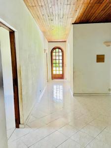 an empty room with a ceiling and a window at Villa Rapide in Ambanja
