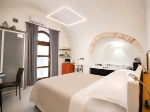 a hotel room with a bed and a sink at Ostuni Luxury Room in Ostuni