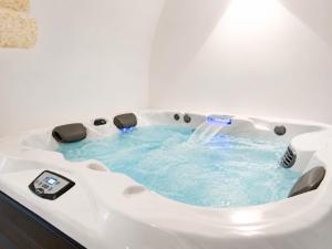 a jacuzzi tub with a water fountain in a bathroom at Ostuni Luxury Room in Ostuni +28 photos