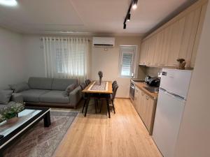 a kitchen and a living room with a table and a couch at Lenci's Apartment in Berat +25 photos