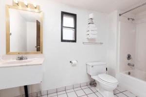 a bathroom with a toilet and a sink and a mirror at Marianna Inn Panguitch in Panguitch +38 photos