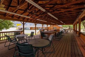 a covered deck with tables and chairs on it at Marianna Inn Panguitch in Panguitch