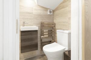 a bathroom with a toilet and a sink at Park View En-Suite in Egham +22 photos
