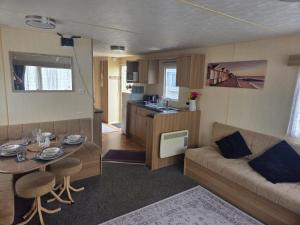 a living room with a couch and a table at Beautiful 8 Berth - Caravan - Abergele in Abergele