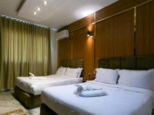 a hotel room with two beds with towels on them at Happy View INN in Giza