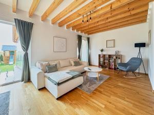 a living room with a couch and a chair at Chaletka Tatry in Nová Lesná