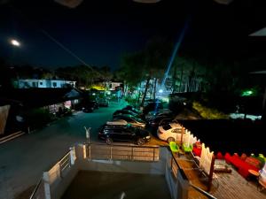 a group of cars parked in a parking lot at night at Ramadani Apartments in Velipojë +53 photos