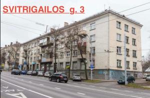 a street with cars parked in front of a building at Budget Room Vilnius in Vilnius