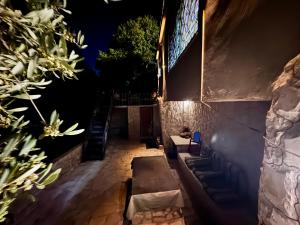 a patio at night with couches and plants at Oak Farm مزرعة الملّول in Ajloun