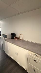 a kitchen counter with a clock on top of it at Velora Stays in Kelowna +4 photos