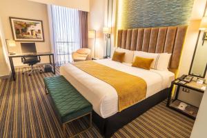 a hotel room with a large bed and a desk at Sonesta Hotel Arequipa in Arequipa +69 photos