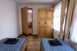 a room with two beds and a door to a bedroom at Chalupa Šťastný kopec in Deštné v Orlických horách