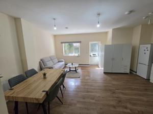a living room with a table and a couch at Shamrock Premium Apartment in Cork