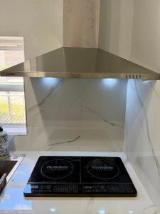 a stove top in a kitchen with a counter top at View Private Suite near LEGOLAND, Downtown & Hospital in Winter Haven