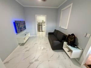 a living room with a couch and a television at View Private Suite near LEGOLAND, Downtown & Hospital in Winter Haven +4 photos