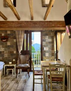 a living room with a table and a chair at Green House Skiathos in Skiathos