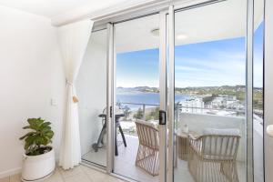 a balcony with a view of the ocean at 'Still & Sea' in Yeppoon's CBD in Yeppoon