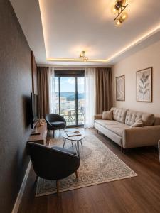 a living room with a couch and a tv at Becici residance pool and sauna in Bečići
