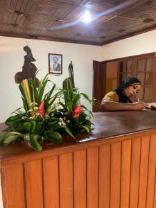 a woman brushes her teeth at a hair salon at Hôtel Les Pyramides in Yaoundé