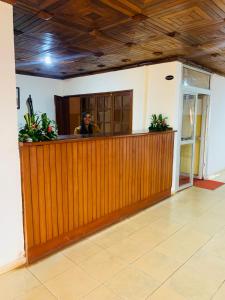 a man sitting at a bar in a building at Hôtel Les Pyramides in Yaoundé