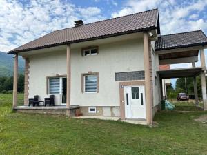 a small house with a porch and a door at Visitor Apartment-Plav in Plav