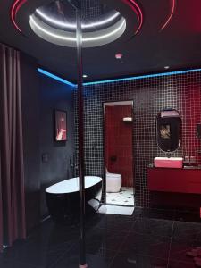 a bathroom with a tub and a sink and a toilet at Benri Hotel Signature in Ho Chi Minh City +161 photos