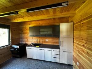 a kitchen with a refrigerator and a stove in a room at Agro Arge in Rožaje +13 photos