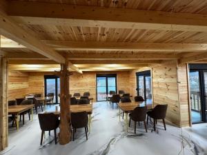 a room with wooden walls and tables and chairs at Agro Arge in Rožaje