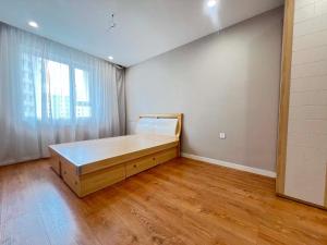 a room with a bed and a large window at Mandala Garden Luxury Apartment in Ulaanbaatar
