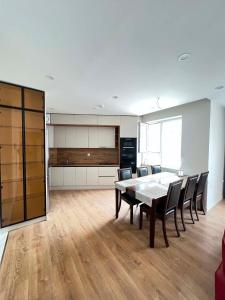 a kitchen and dining room with a table and chairs at Mandala Garden Luxury Apartment in Ulaanbaatar +2 photos