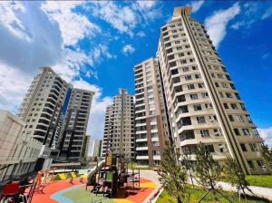 a playground in front of two tall buildings at Mandala Garden Luxury Apartment in Ulaanbaatar