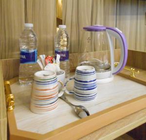 a table with plates and bottles of water and a kettle at Happy View INN in Giza +182 photos