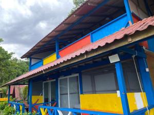 a colorful house with a red roof at Cabañas Guaimia in Nuquí